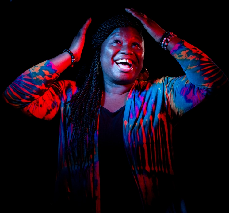 Lohifa, smiling community member and influencer, with hands on her head.