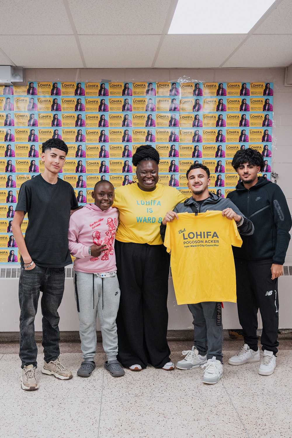 Lohifa Pogoson Acker posing for a photo with kids from Ward 8
